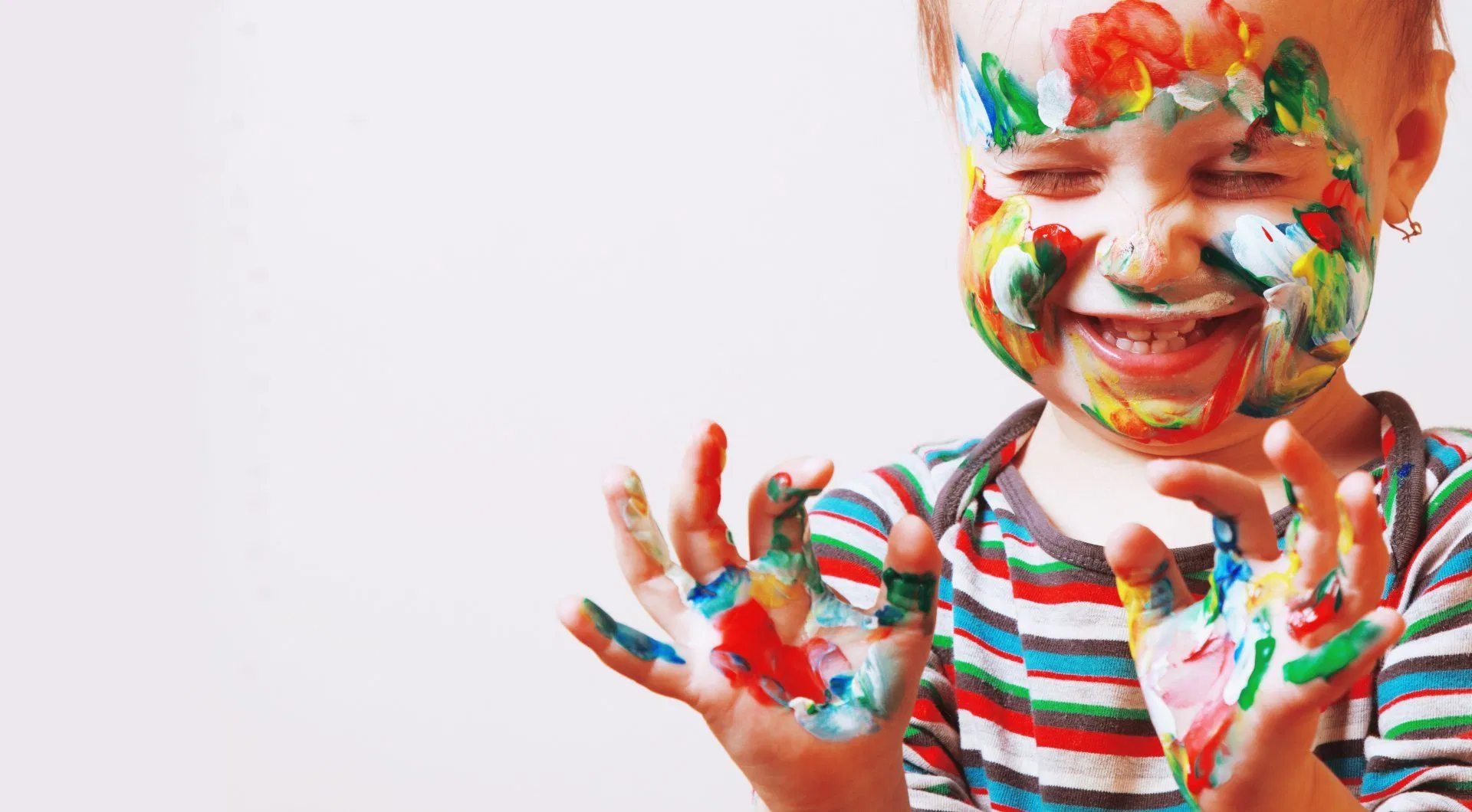 Toddler enjoying hands-on finger-painting and sensory creativity
